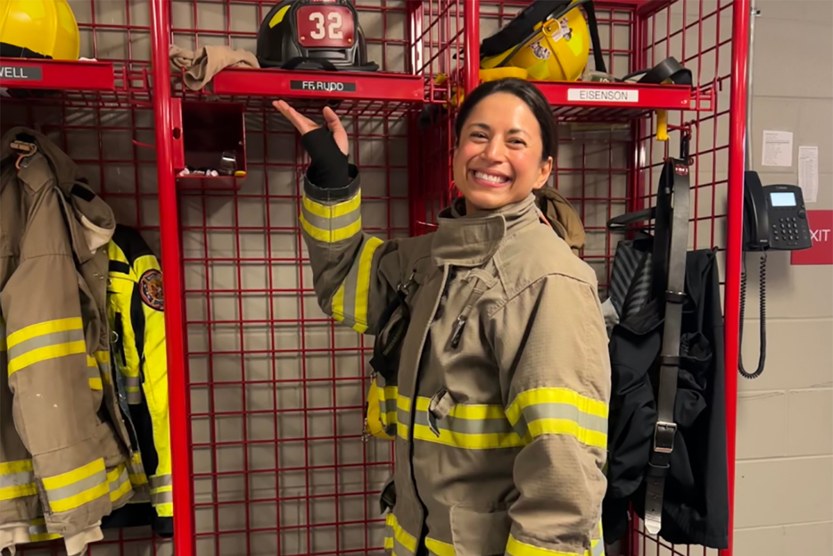 Fire woman with firefighting equipment at the fire station.